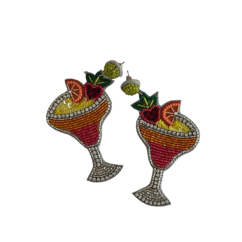 Pair of earrings designed like margarita glasses with fruit on a light gray background