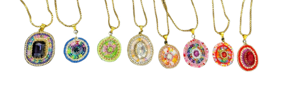 Set of necklaces with colorful pendant designs on a gray background