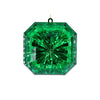 Green gemstone with a faceted surface on a white background