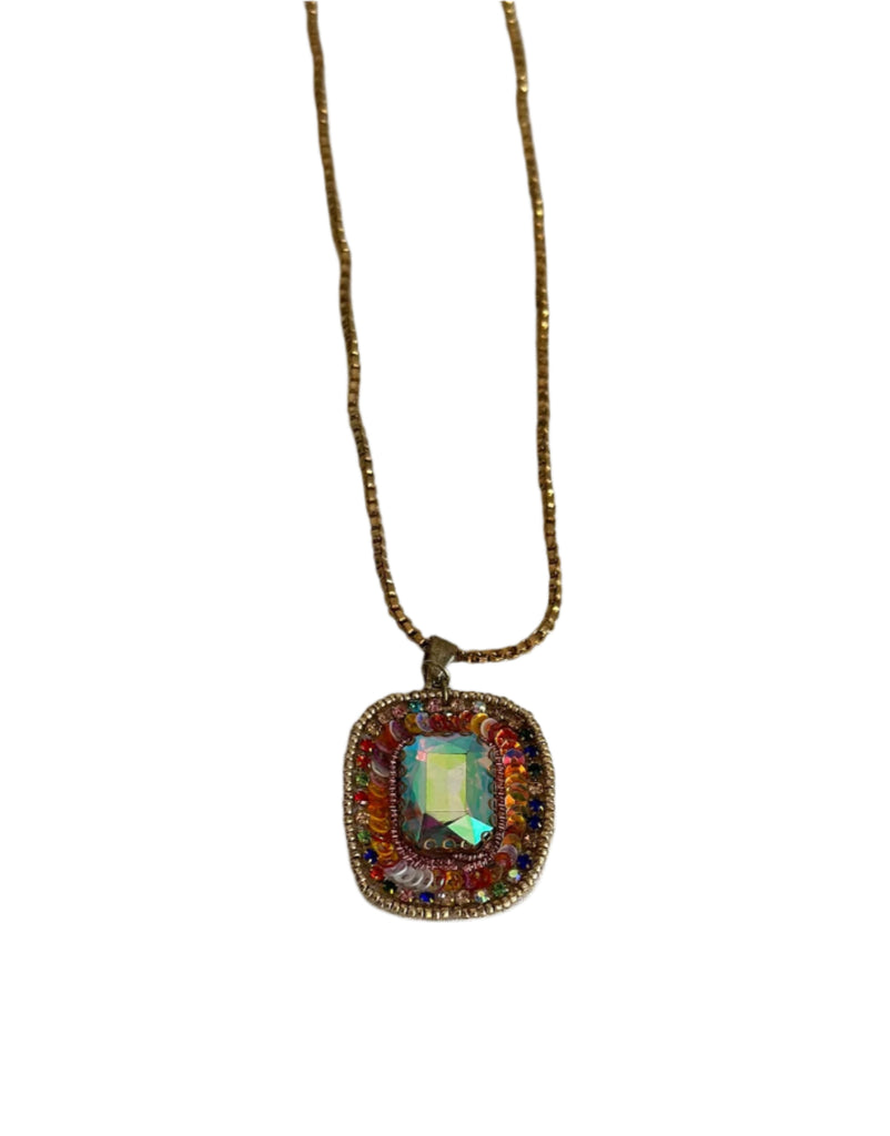 Necklace with a colorful pendant on a plain background