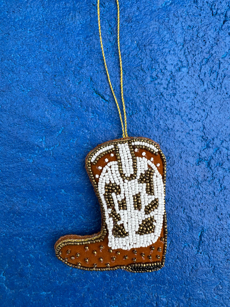 Decorative item with beadwork on a blue textured background