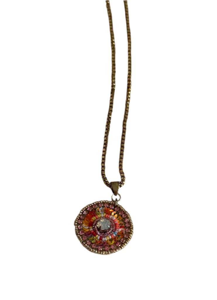 Necklace with a colorful pendant on a plain background