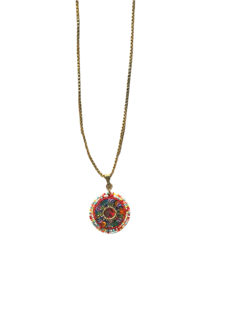 Necklace with a colorful pendant on a wooden surface