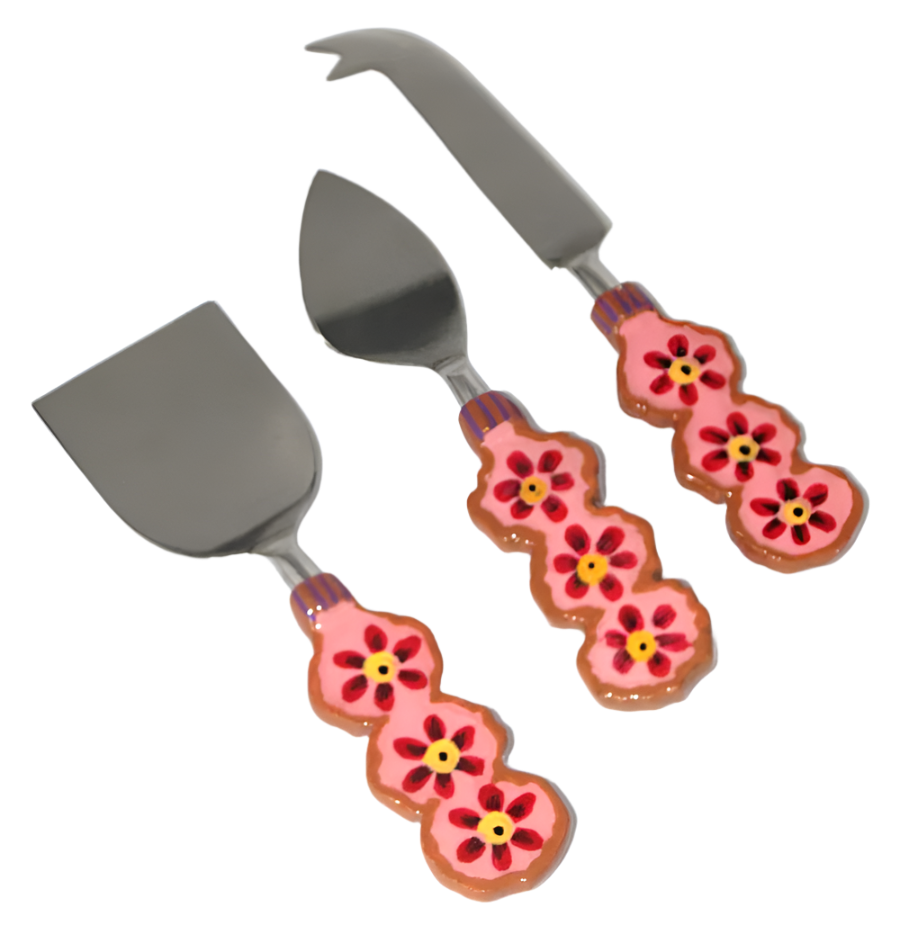 Set of three cheese knives with floral handles on a white background